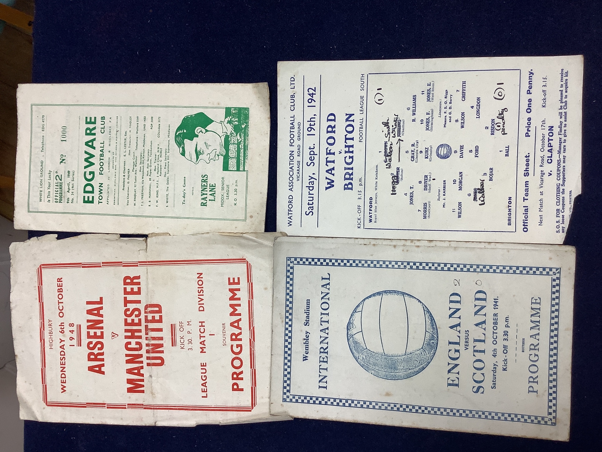 A collection of stamps, coins, banknotes, football programmes from 1942, playing cards and a book.